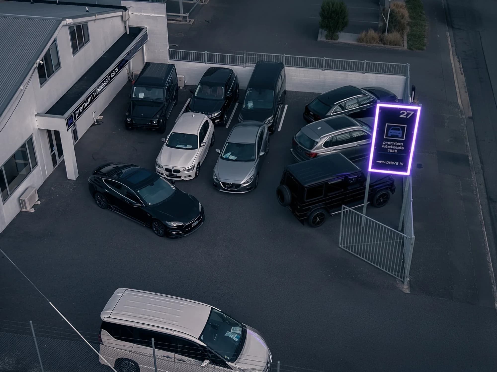 Premium Wholesale Cars dealership at 27 Watts Road, Sockburn, Christchurch, at dusk